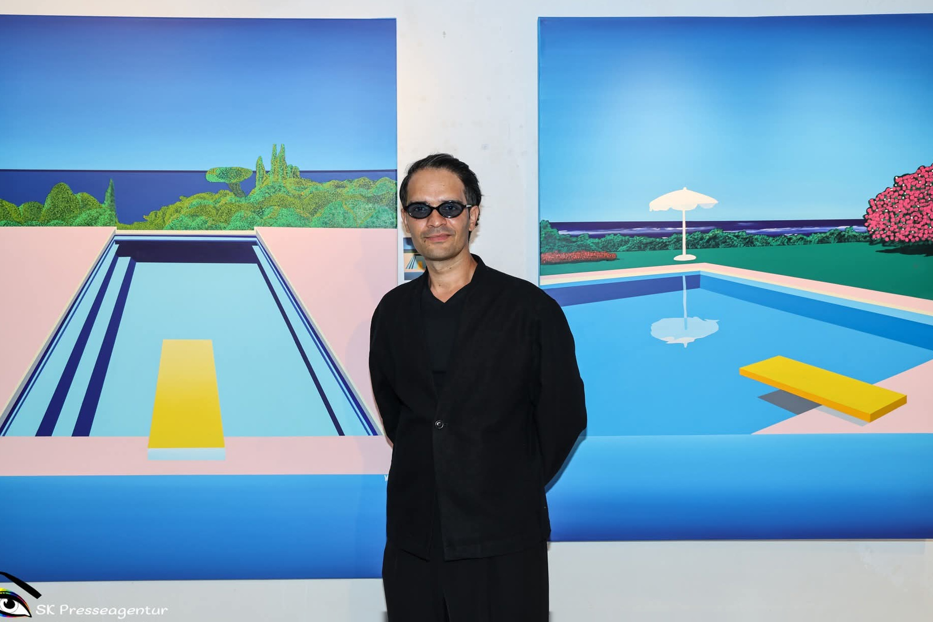 Vijit Veer Hooda in front of two of his pool paintings